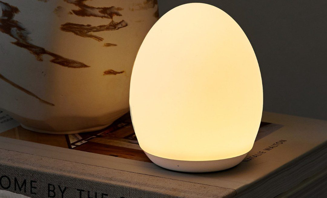 bodie breastfeeding night light glowing on a bedside table